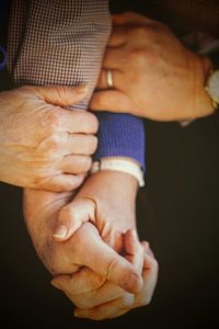 Image of several people holding hands